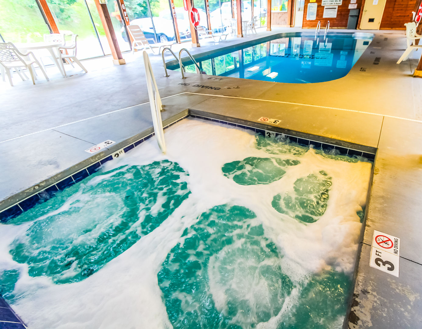 An indoor swimming pool and Jacuzzi at VRI's Smoketree Lodge in North Carolina.